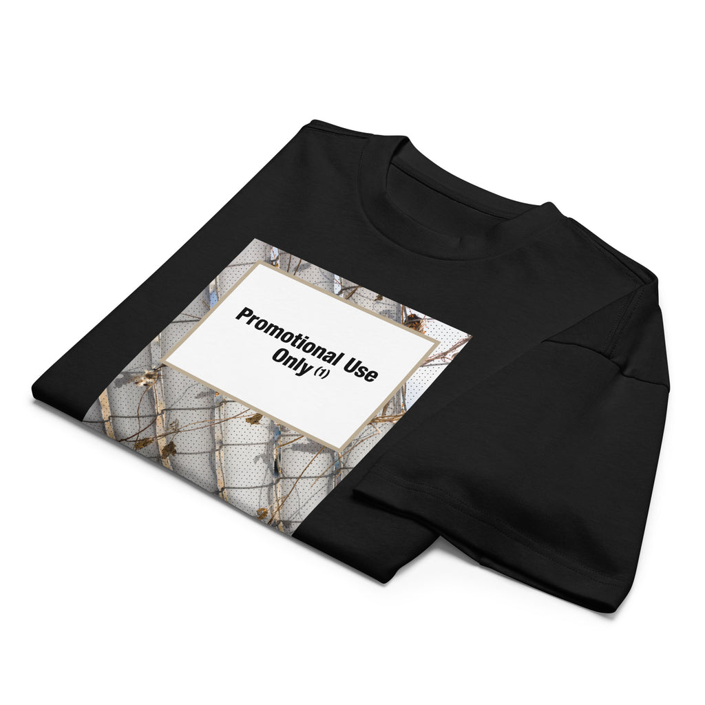 Black t-shirt with graphic print of a chain-link fence covered in dried vines. Reads “Promotional Use Only” designed by The Zigzag Stitch