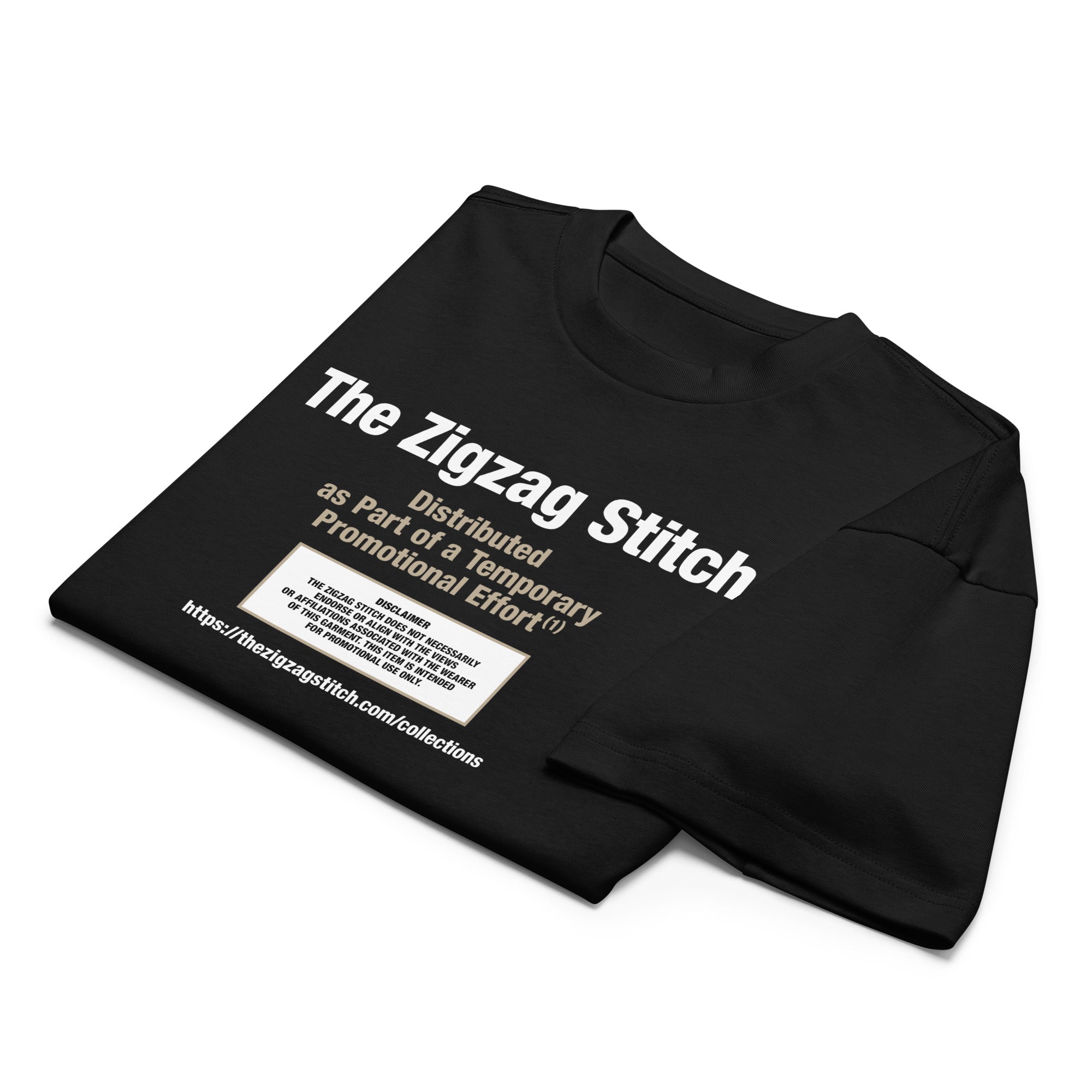 Folded view of black t-shirt with graphic print. Reads “Distributed as Part of a Promotional Effort” designed by The Zigzag Stitch