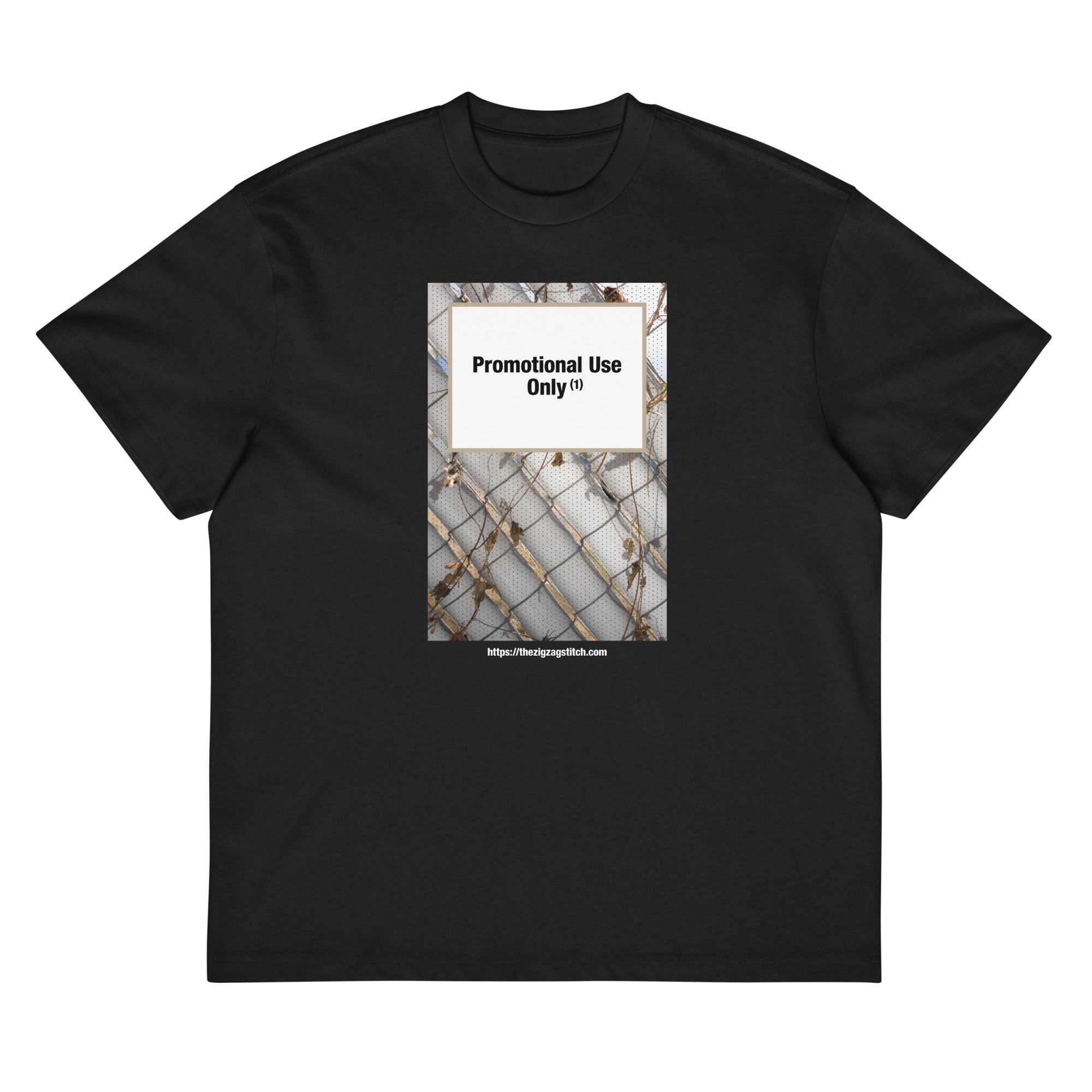 Black t-shirt with graphic print of a chain-link fence covered in dried vines. Reads “Promotional Use Only” Designed by The Zigzag Stitch