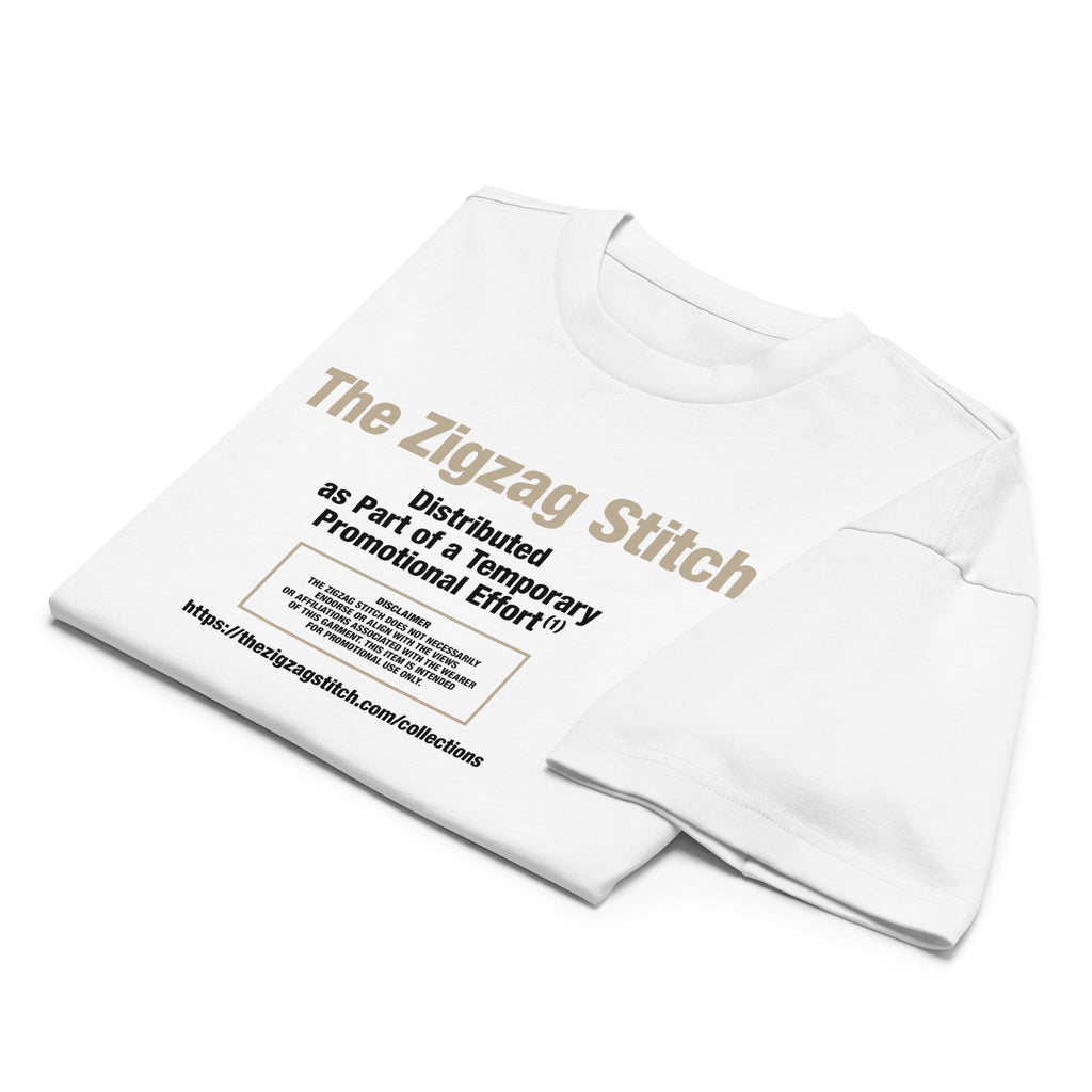 Folded view of white t-shirt with graphic print. Reads “Distributed as Part of a Promotional Effort” designed by The Zigzag Stitch