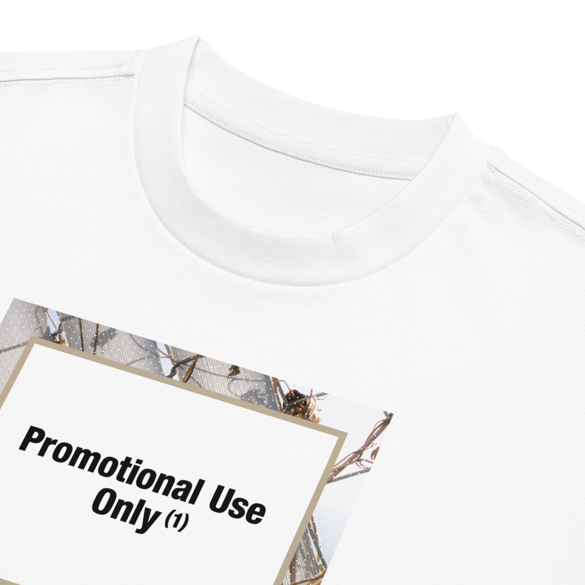 Product Close-up of neckline and chest print on a white t-shirt. Graphic shows a fence background with the words “Promotional Use Only” designed by The Zigzag Stitch